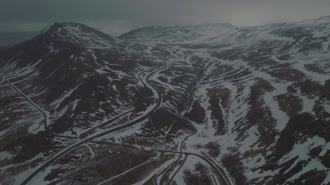 Dark Winter Scene of Snowy Mountain Roads of Iceland Aerial