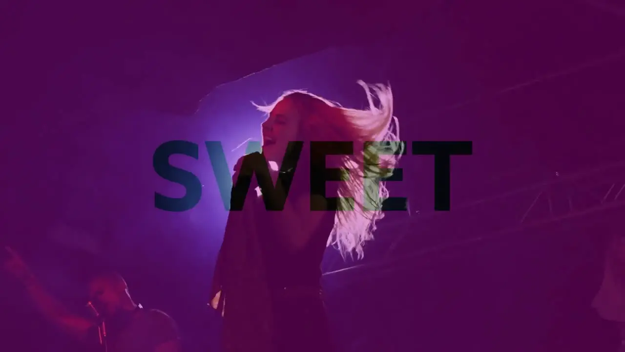 Animation of sweet text over woman singing during concert on stage with purple tint