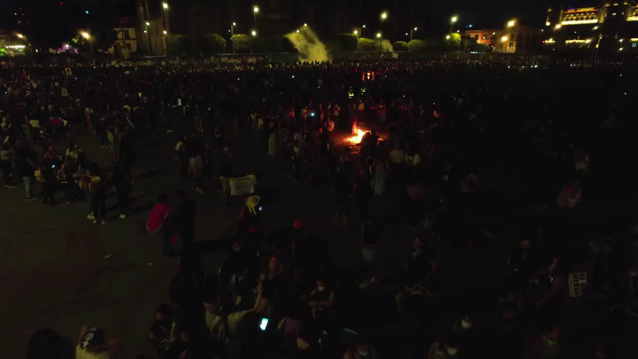 Aerial view of women burning stuff on the streets of a city protesting the rise of hate crimes against females in Mexico