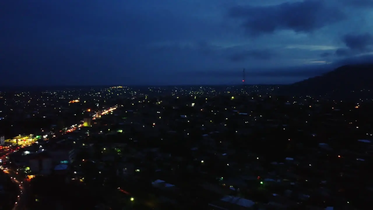 Panoramic aerial view over a illuminated Etoug-ebe neighborhood in the city of Yaounde dusk in Cameroon