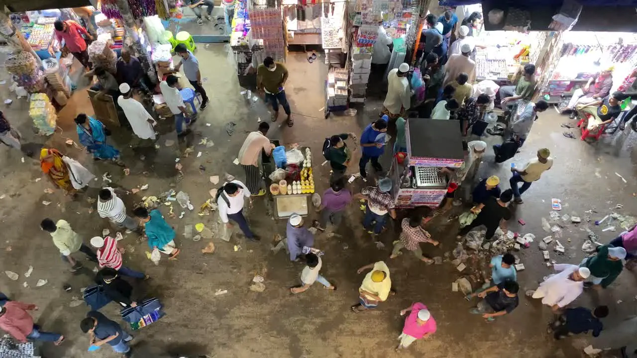 Busy food market at night People crossing the street market with food stalls Directly above shot