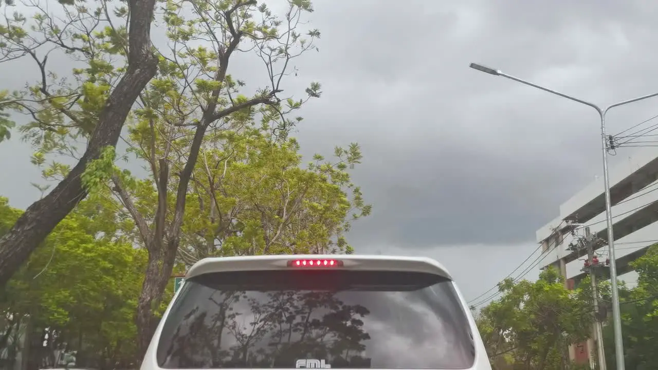 Rear Vehicle with Overcast Clouds Above While Waiting in Traffic in Thailand