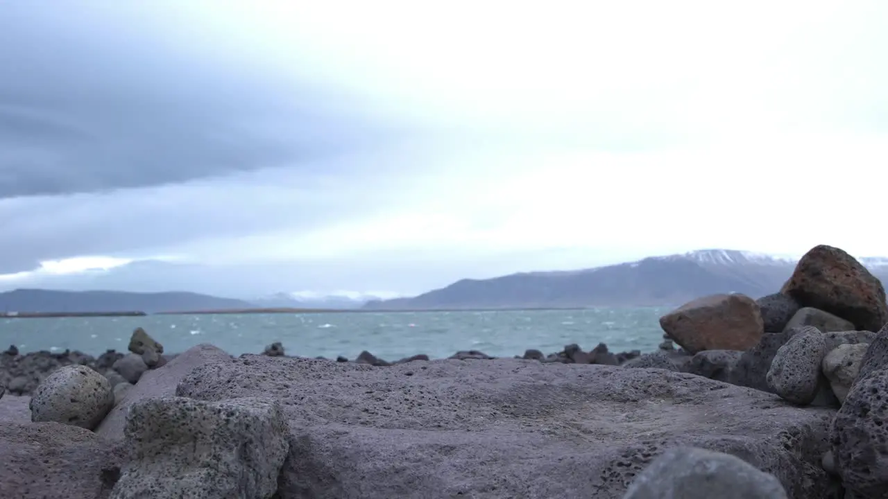 Volcanic pumice stones on the ocean coast of Iceland cloudy weather