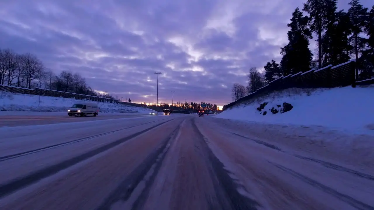 POV shot driving along a freshly gritted snowy highway in Helsinki