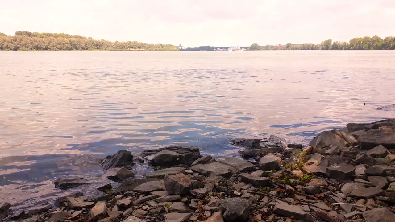 Sunny day on the Danube river with beautiful cloudy sky and rocky beach