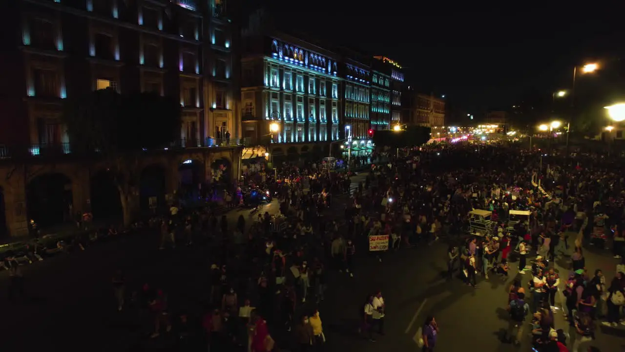 People marching for women rights on illuminated night streets of Mexico city Aerial view