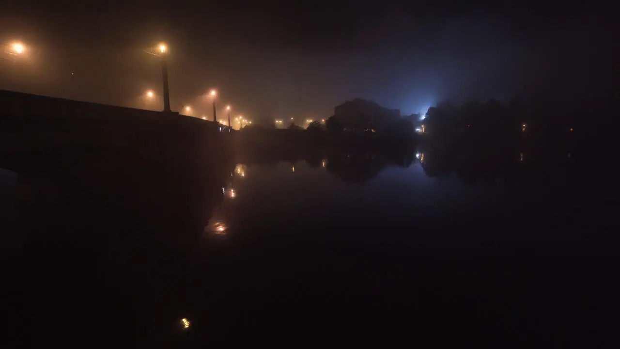 Manes bridge over Vltava river at night in mist Prague Czechia streetlights