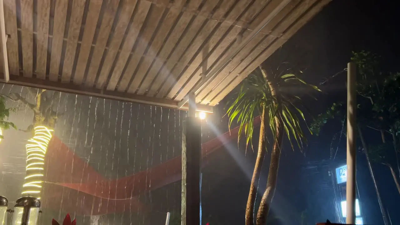 Night tropical storm in Bali Wooden porch view with thunderstorm and bolts of lightning