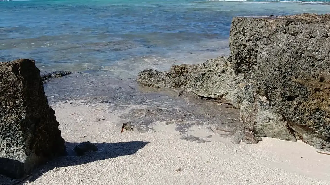 Bahamas Sea water breaking gently onto rocks Closeup