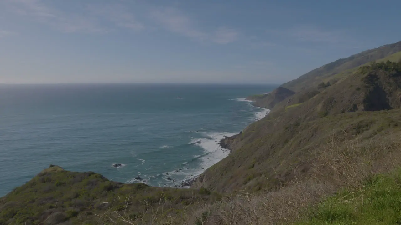 Stationary distance shot of the Pacific Ocean along the hill side of Big Sur California