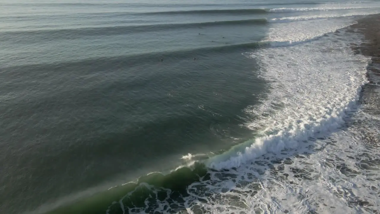 Aerial View of South Africa Jeffrey's Bay surfers ride long waves at The Point surf break