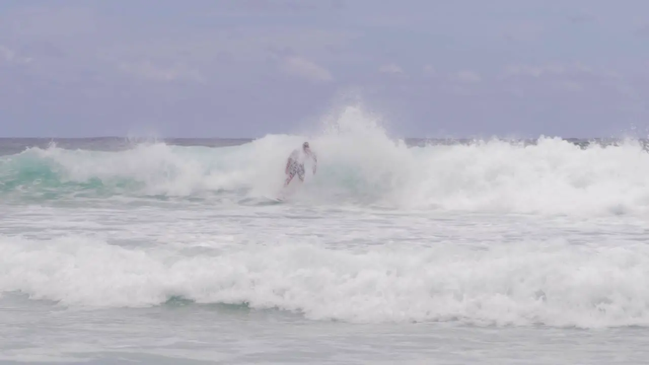 Surfing Surfer Catching Waves At South Gorge Beach Patrolled By Lifeguard On Jet Ski North Stradbroke Island QLD Australia wide shot