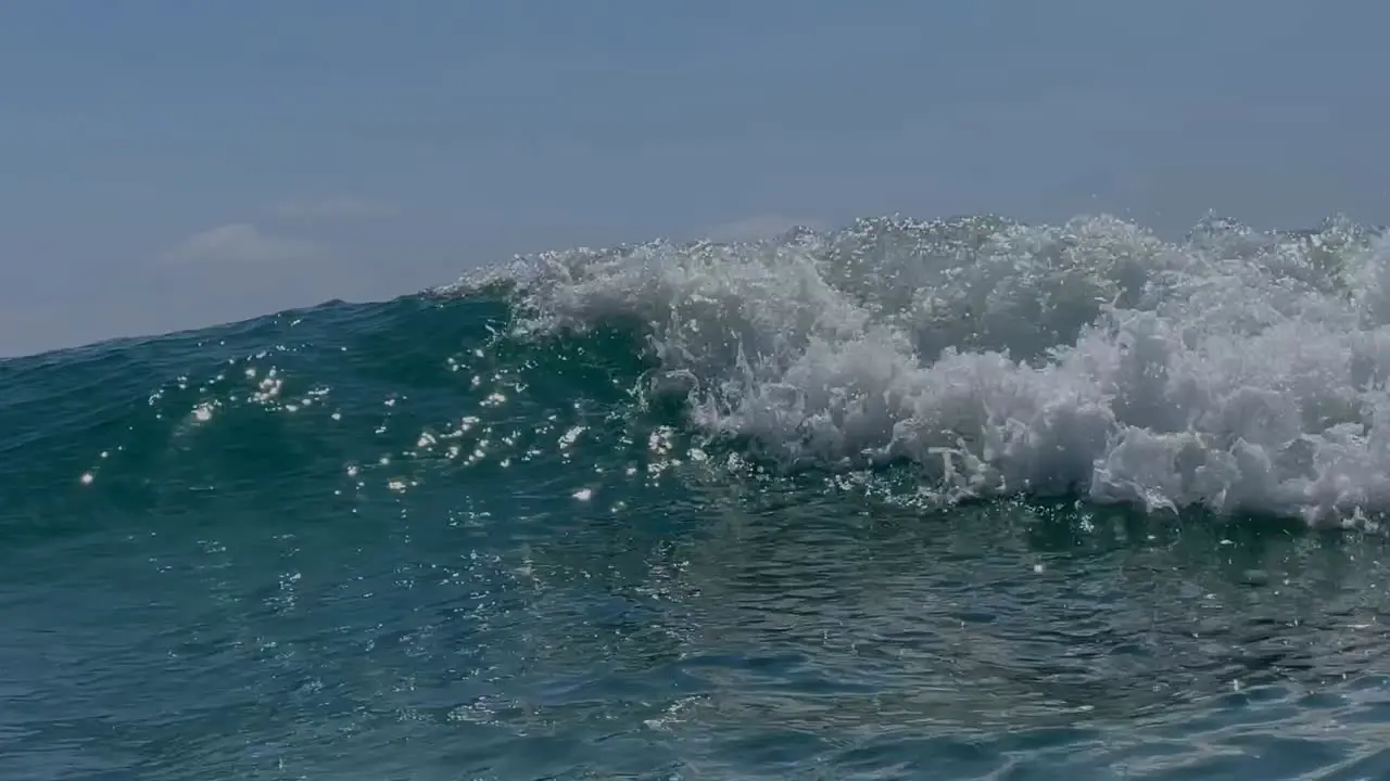 Wave cresting and breaking over camera with the sun shining in Southern Camera