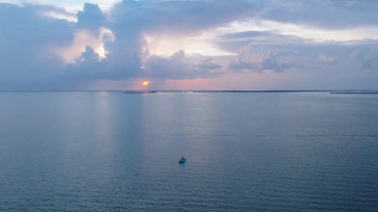 Boat drifting slowly over open ocean in the Florida Keys during gorgeous Sunset