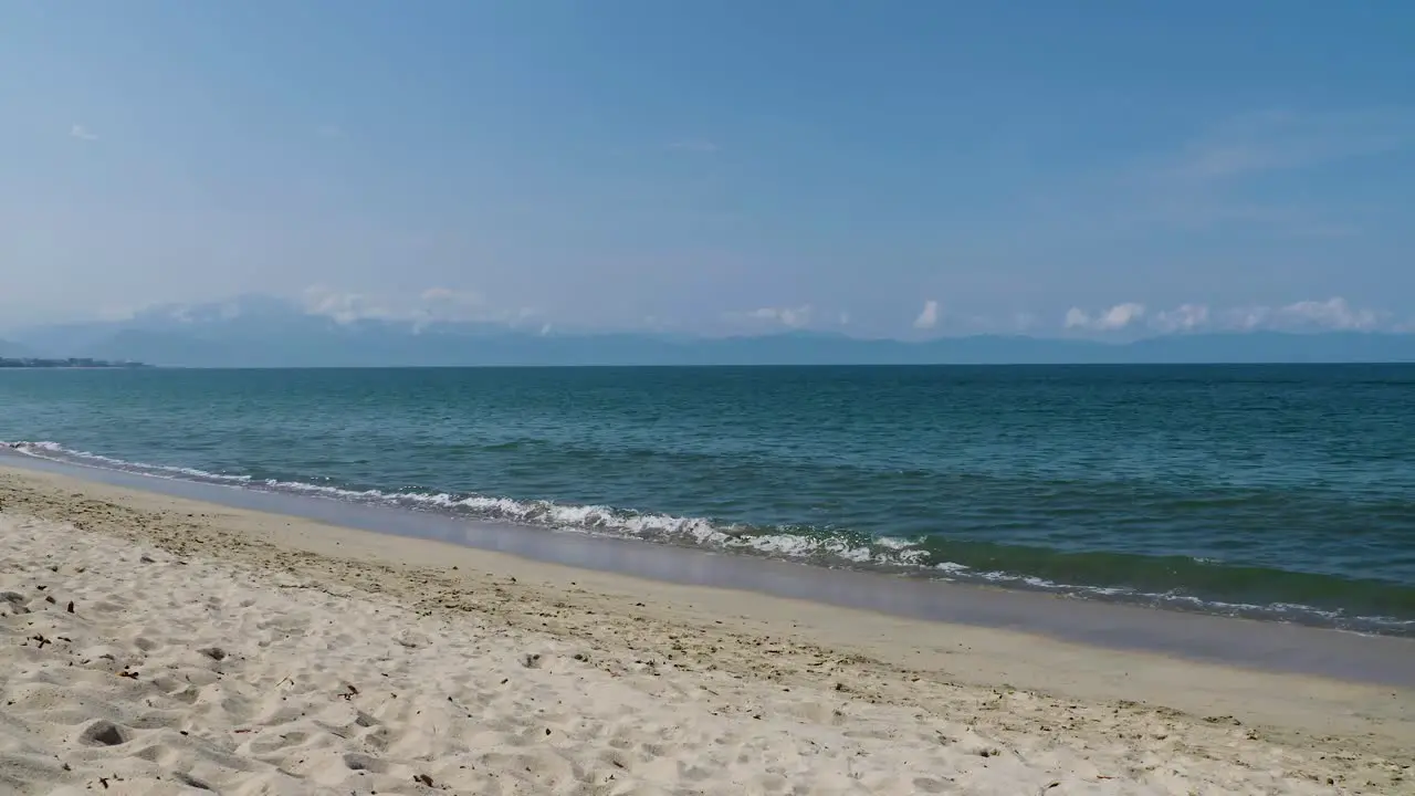 Calmed ocean waves crashing at the beach landscape in Bucerias Mexico