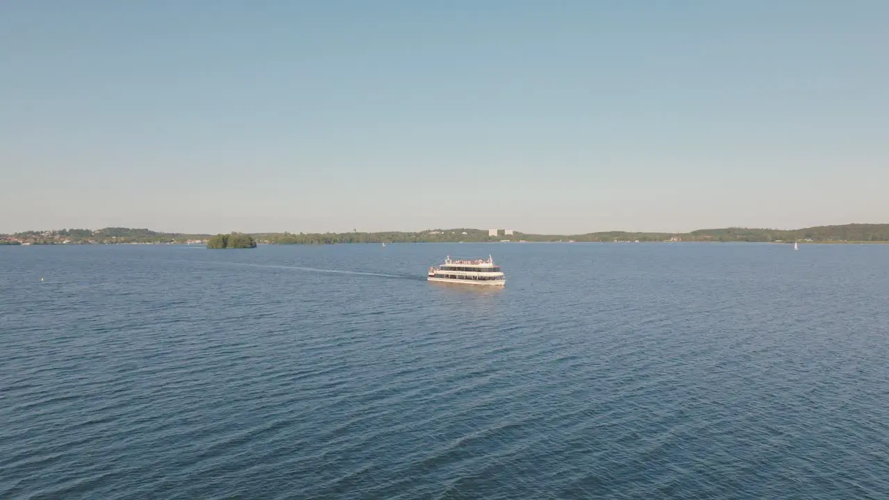 Boat sails serenely on sunny day with gentle waves