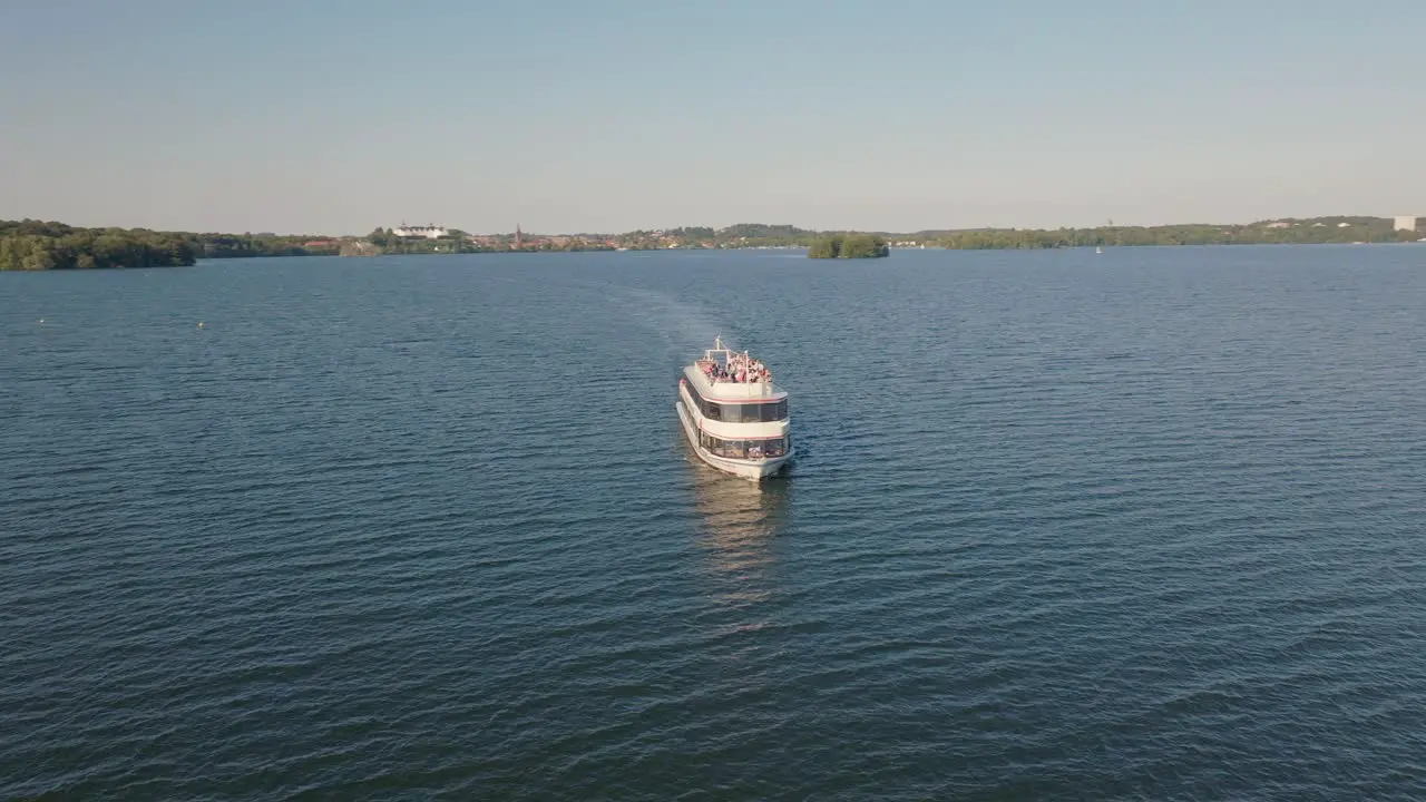 Boat sailing on water on sunny day with small waves