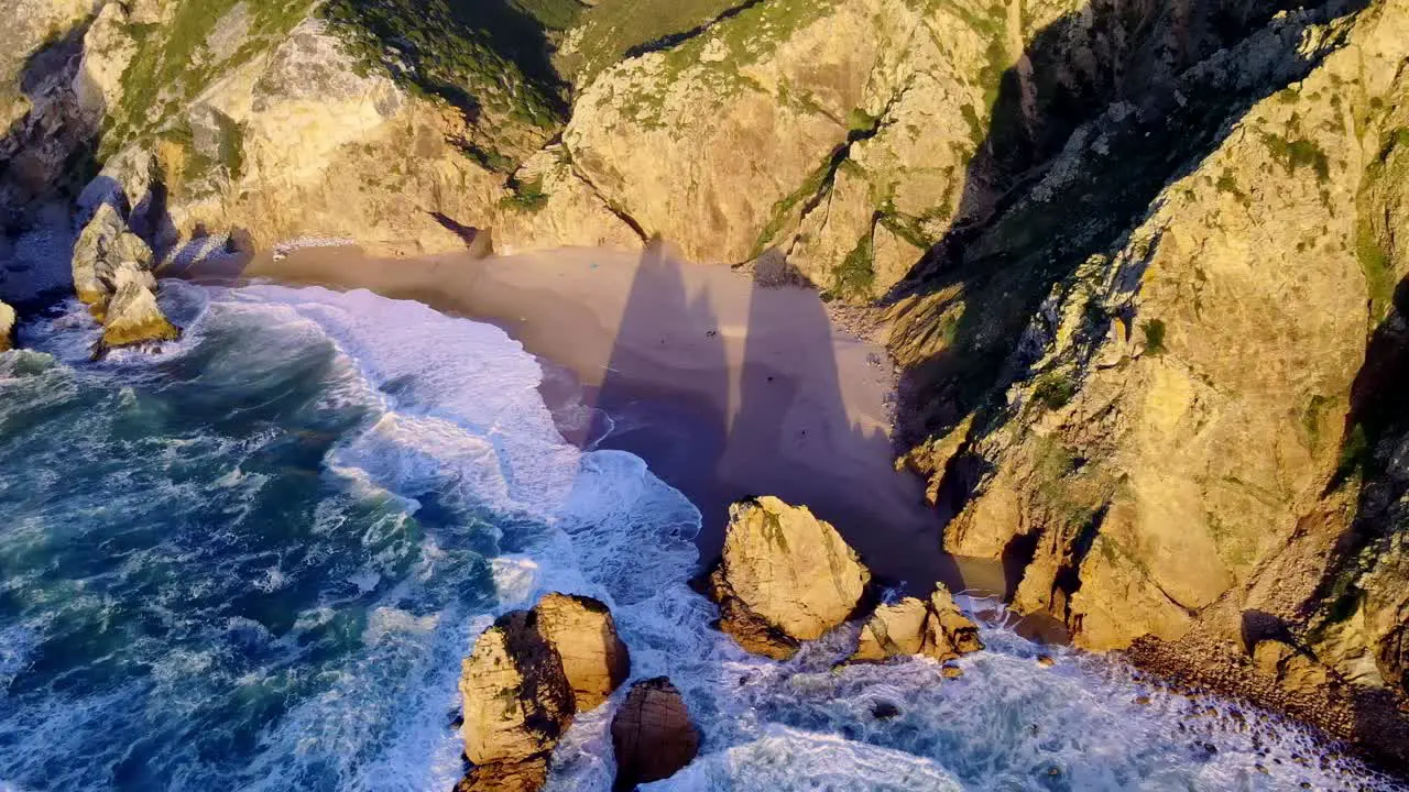 The amazing Ursa beach on thr coast of Sintra Portugal taken at sunset by drone