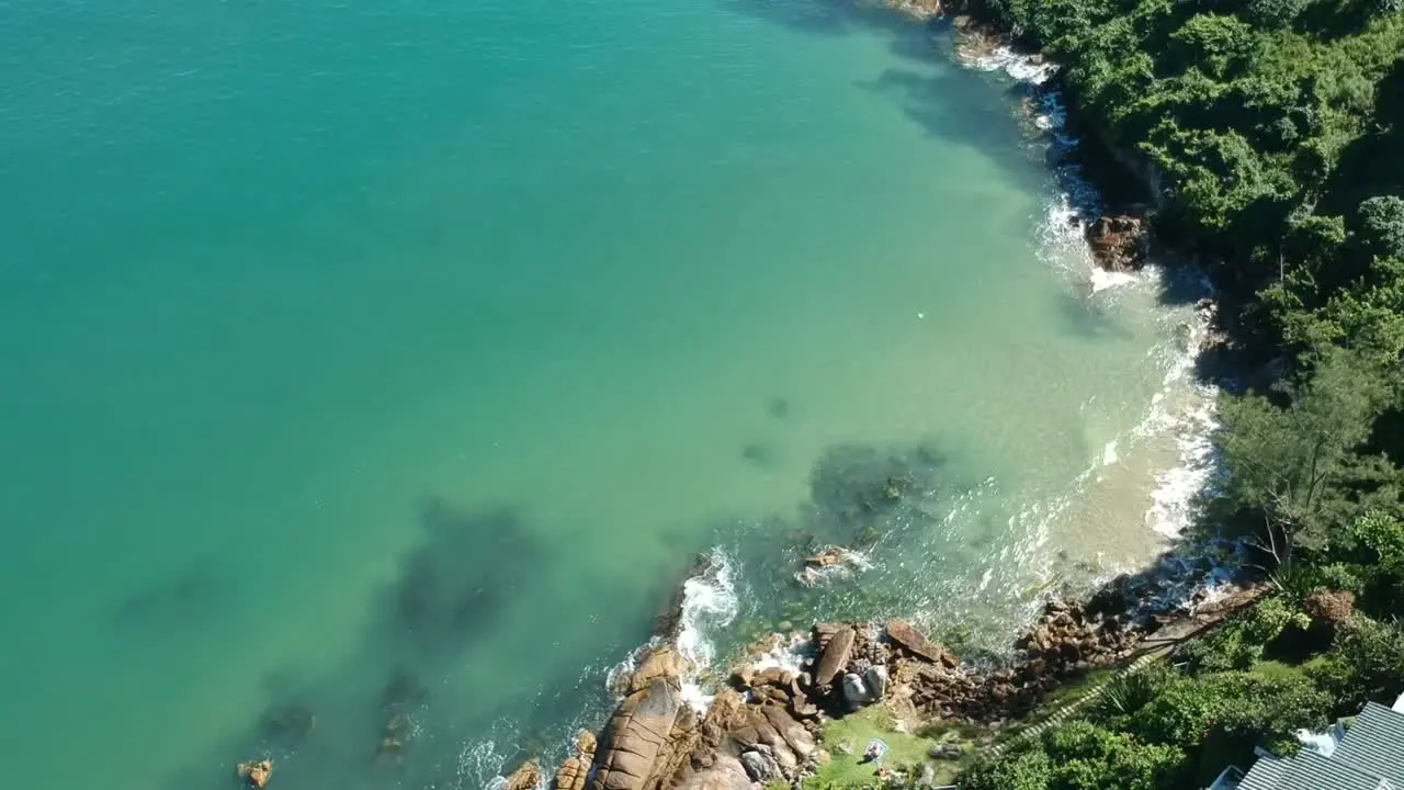 Hovering over a beach with some clear blue water