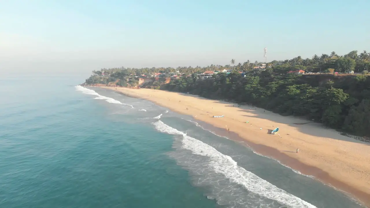 Varkala Beach backed by palm-covered red cliffs