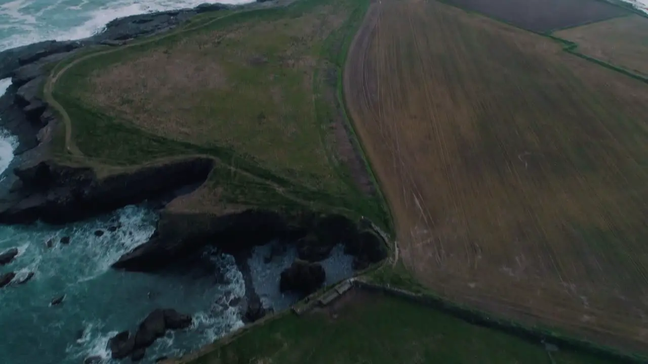 Lighthouse along a rocky shore aerial