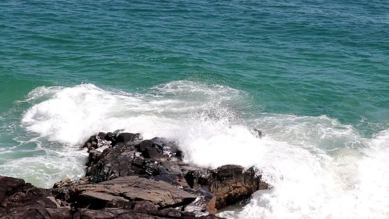 Waves breaking on a big rock