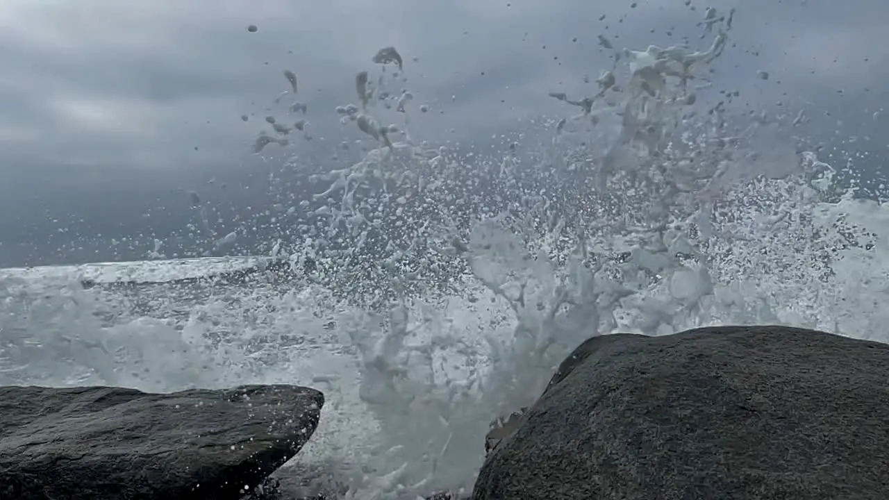 Whitewater splashes over rocks in slow motion in Southern California