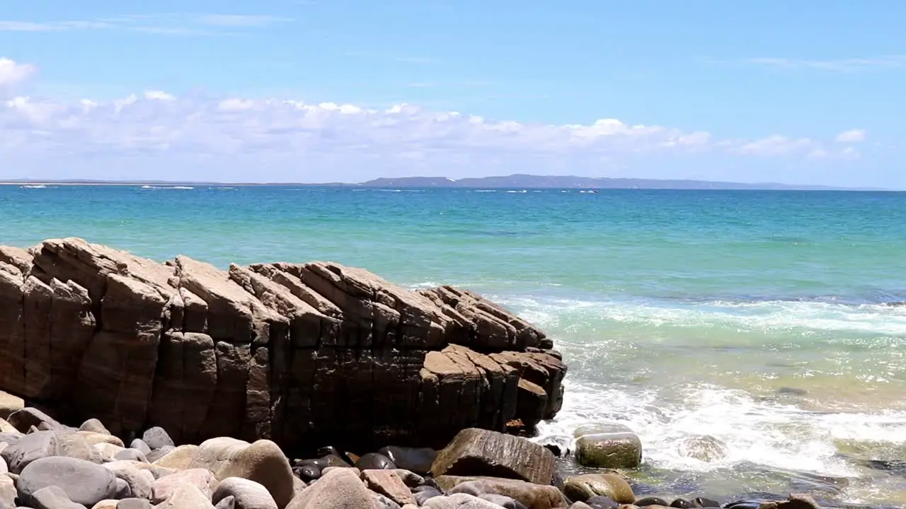 Waves splashing on a big rock