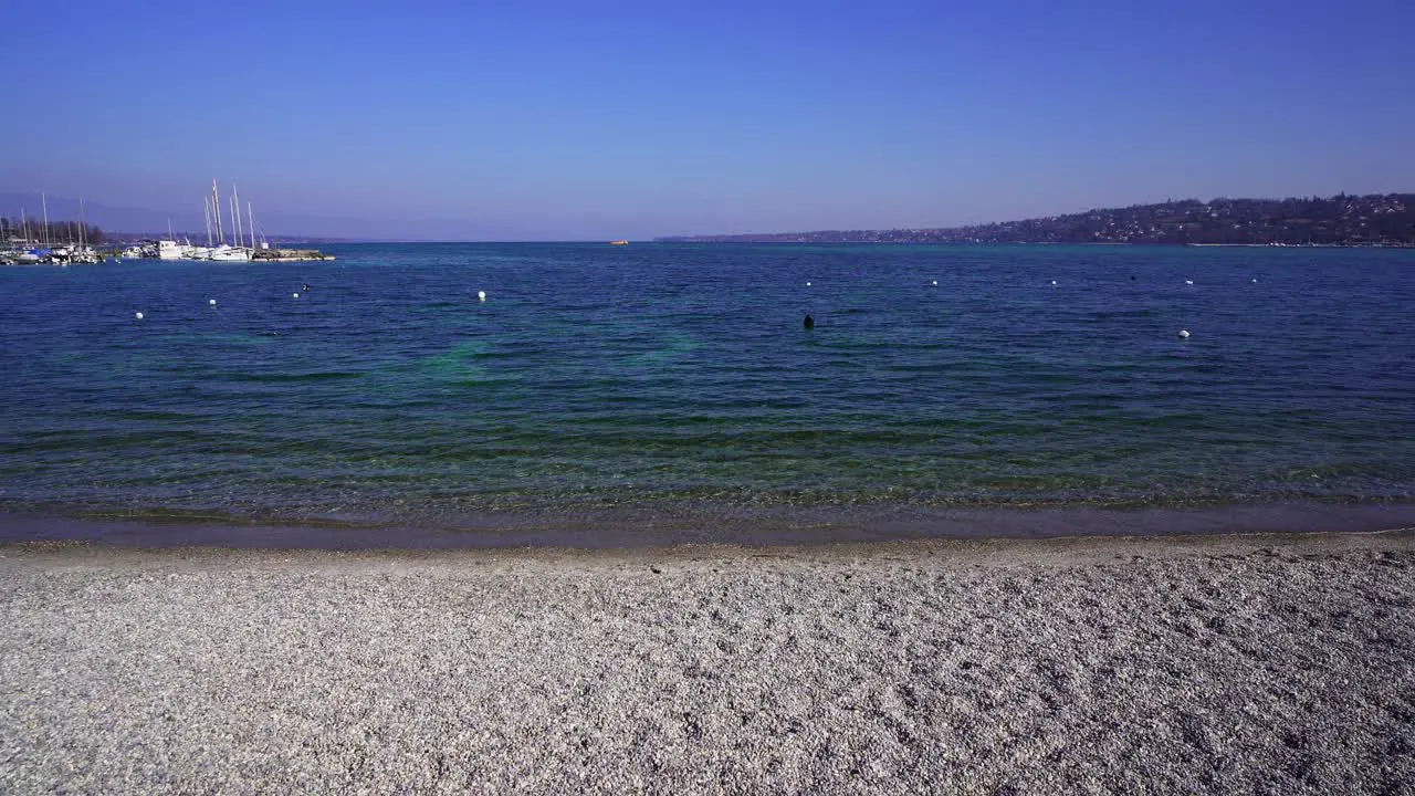 Geneva the small pebble beach on Bains des Pâquis looking out toward Lake Geneva