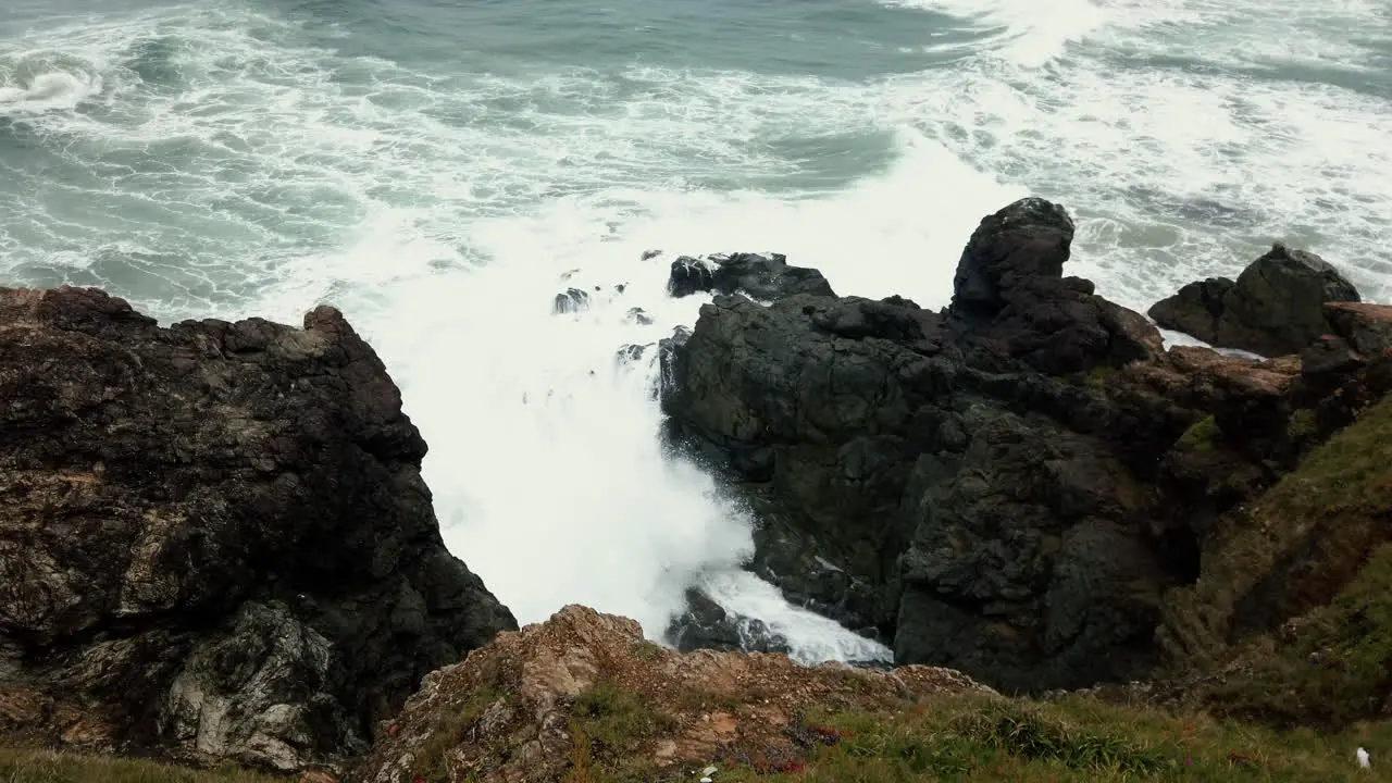 White Waves Breaking Against Cliff In Lighthouse Beach Port Macquarie Australia View From Above high angle shot