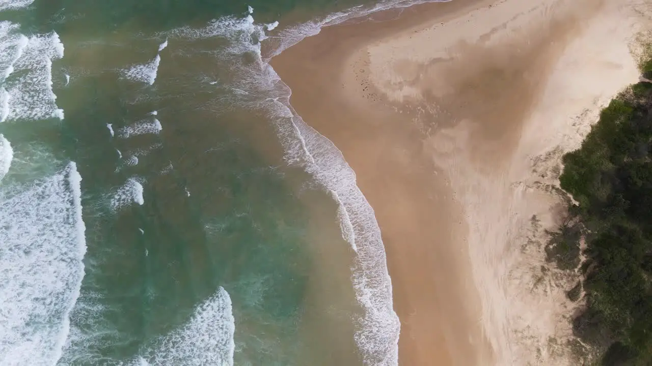 Sunlight Through Golden Sands At Sawtell Beach With Rolling Sea Waves In New South Wales Australia