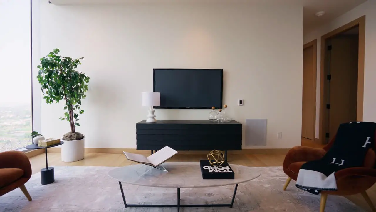 Wide shot of a modern living room with a blank television