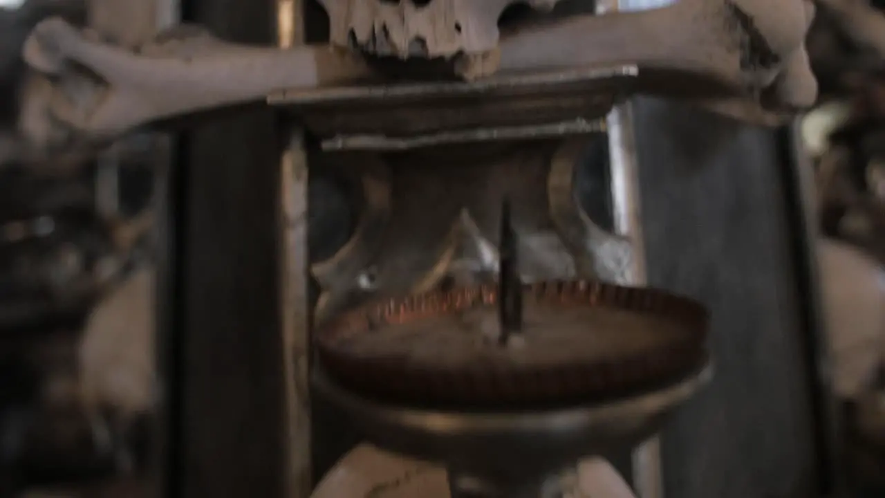 Panning down shot over human skull bones remains decorating Sedlec Ossuary small Roman Catholic chapel