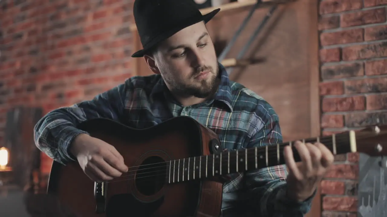 Portrait Of Young Man Musician Playing Guitar At Home