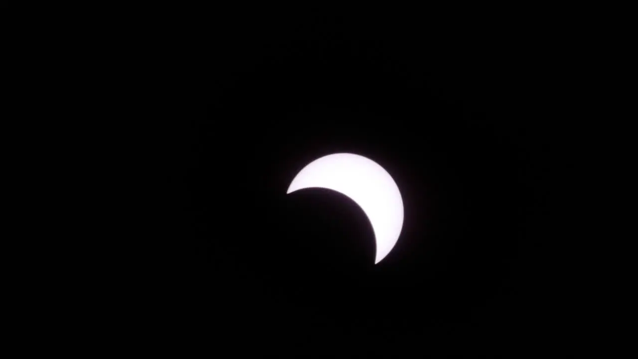 Solar eclipse moon shadow leaving sun time lapse