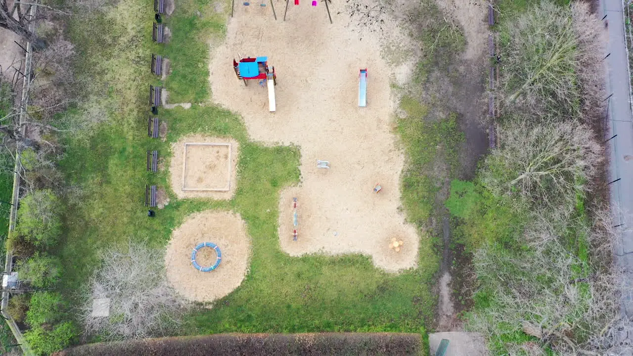 High Angle Aerial View Empty Deserted Children Playground During Covid-19 Virus Outbreak and City Lockdown Top Down Drone Shot