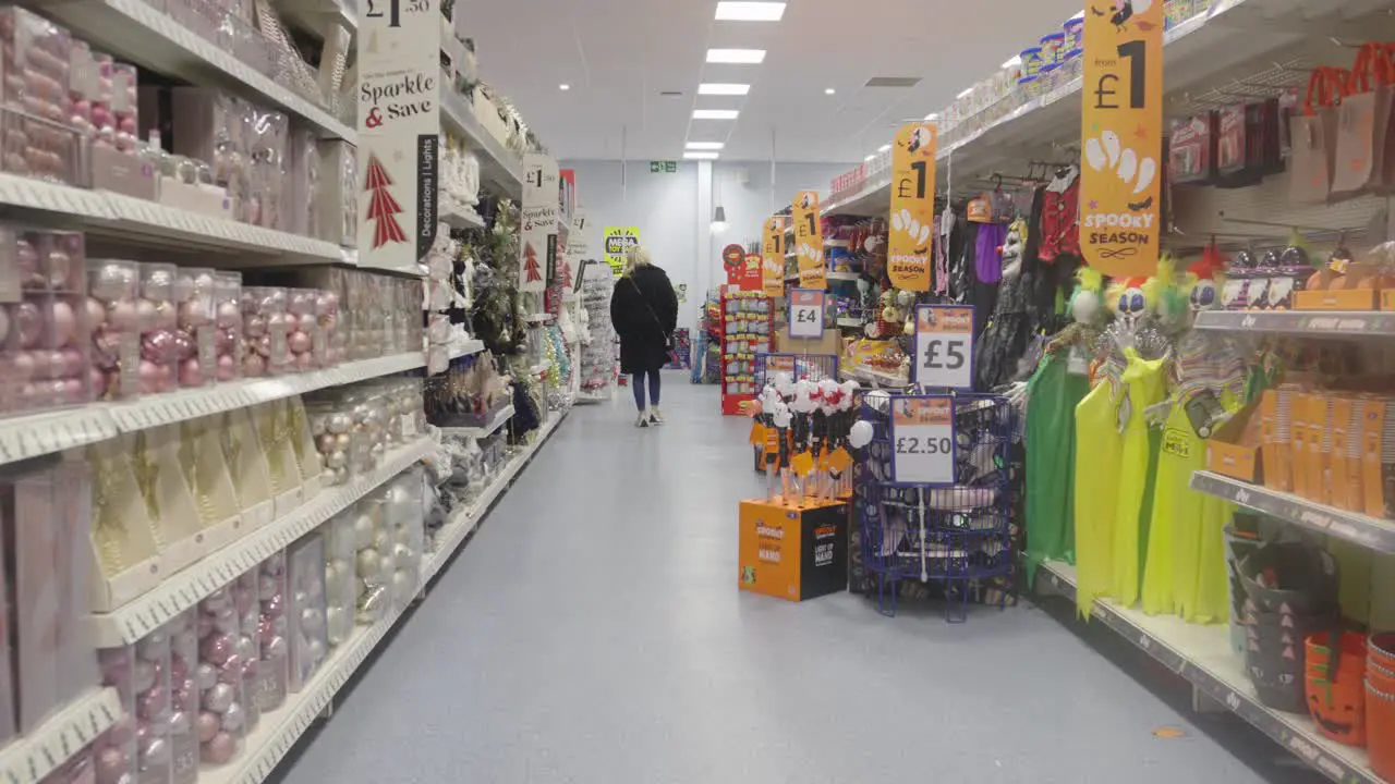 Woman browsing store looking through Halloween decorations Handheld