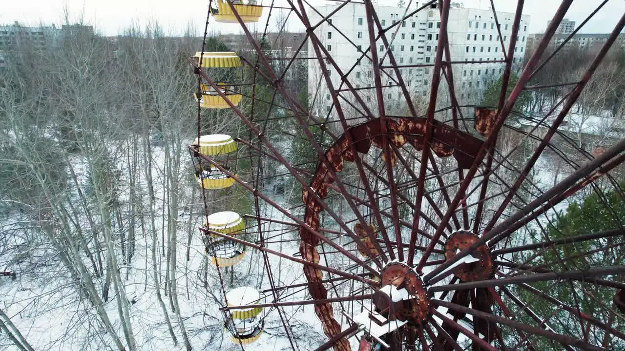 Rusty Ferris Wheel and winter Pripyat city in Chernobyl exclusion zone