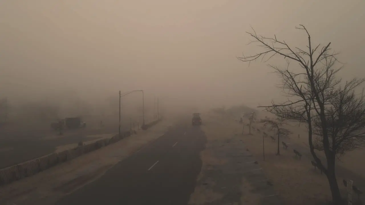 Descending over a spooky and sandy street fog blurring visibility