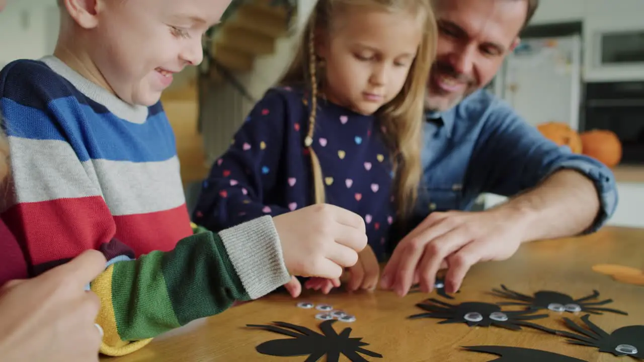 Handheld video of family preparing decorations for Halloween