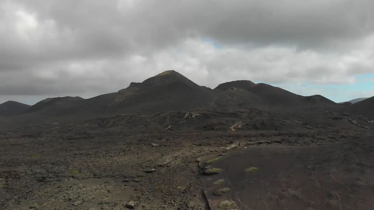 Flying towards a series of volcanic hills in cloudy weather