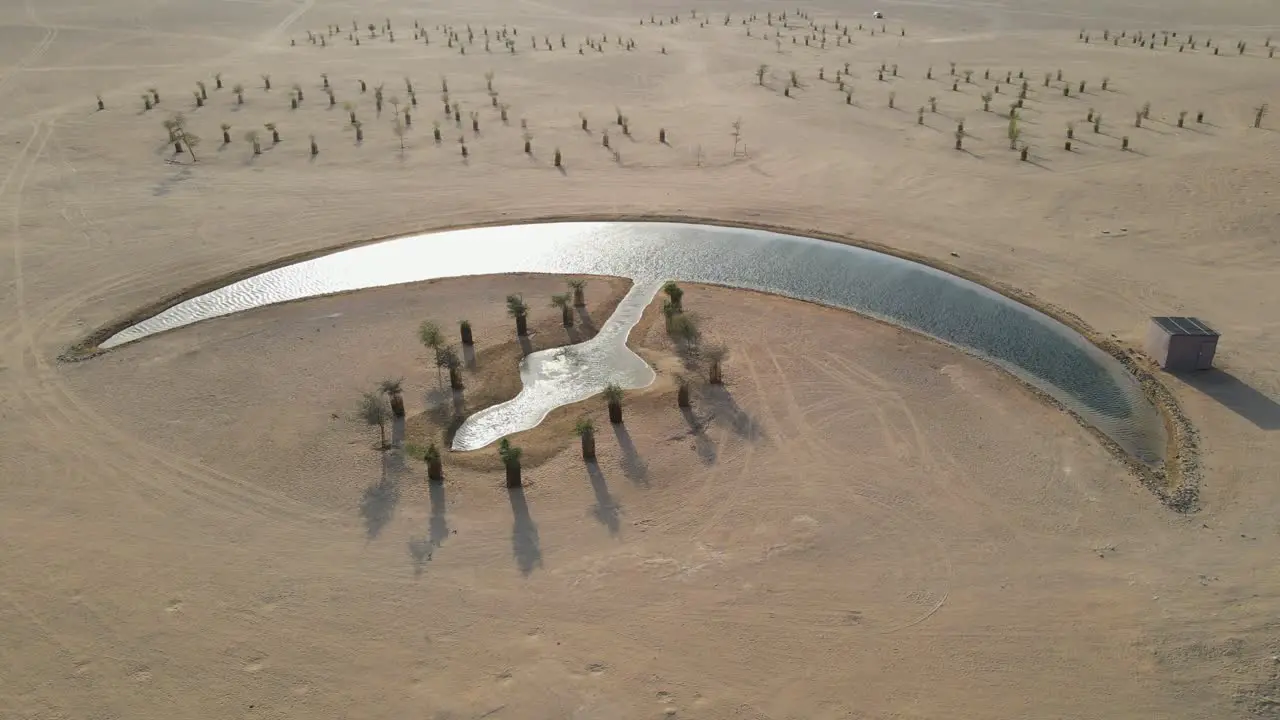 Aerial view of the Moon Lake in Dubai Moon Shape Lake is in the middle of Al Qudra desert surrounded by golden sand dunes in the United Arab Emirates