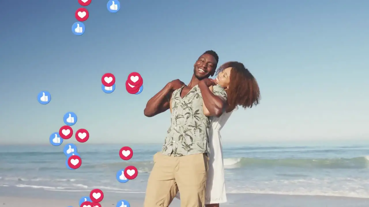 Animation of hearts over african american woman picking up rubbish on beach