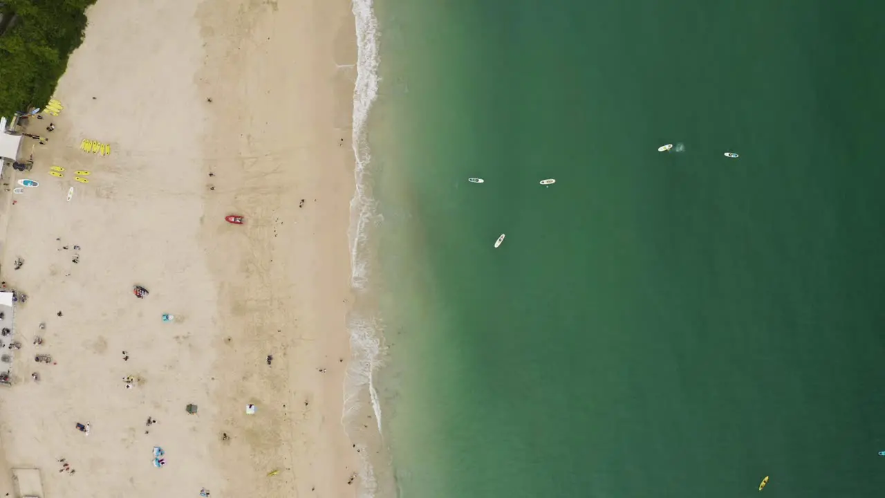 Vertical Shot Of St Ives Seashore With Tourists And Splashing Waves In Cornwall England UK