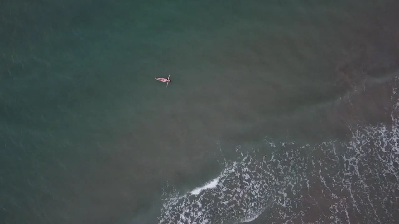 Aerial top shot of female traveler floating above sea with wide reach at Denia las marinas