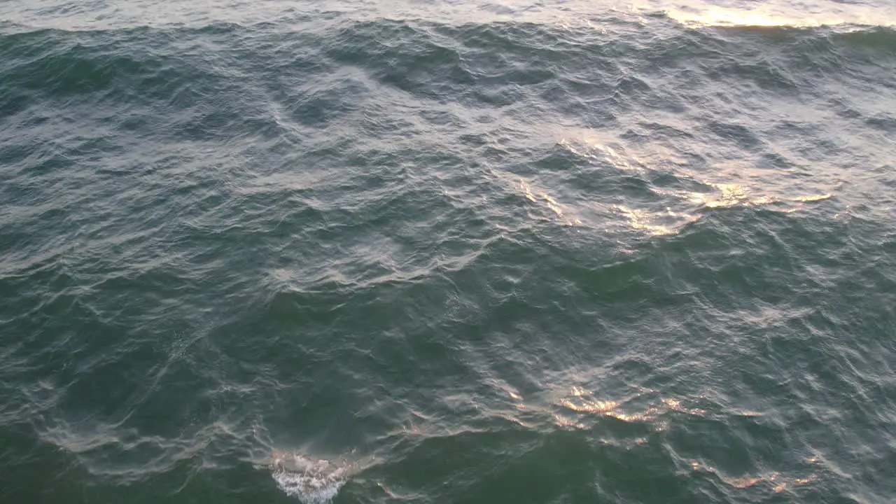 Teal Ocean Waves under a Pink Sunset in Oxnard California ~ 4K Drone Footage of the Ocean at Sunset with a Focus on the Waves and Pan Upwards to Reveal Sunset