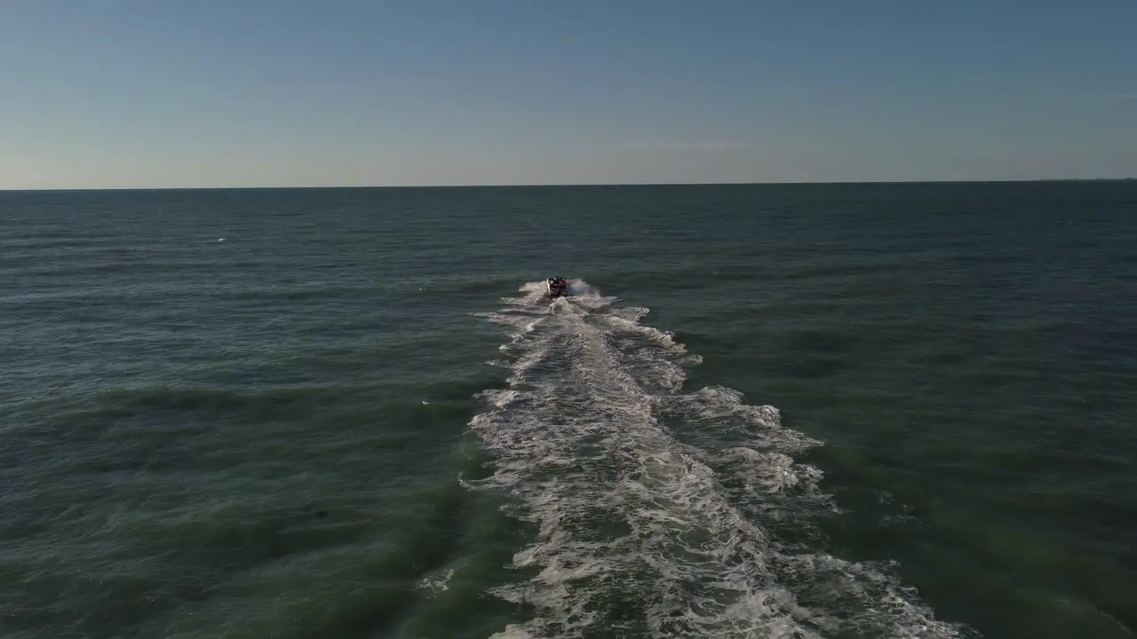 Aerial shot of a boat sailing into the ocean