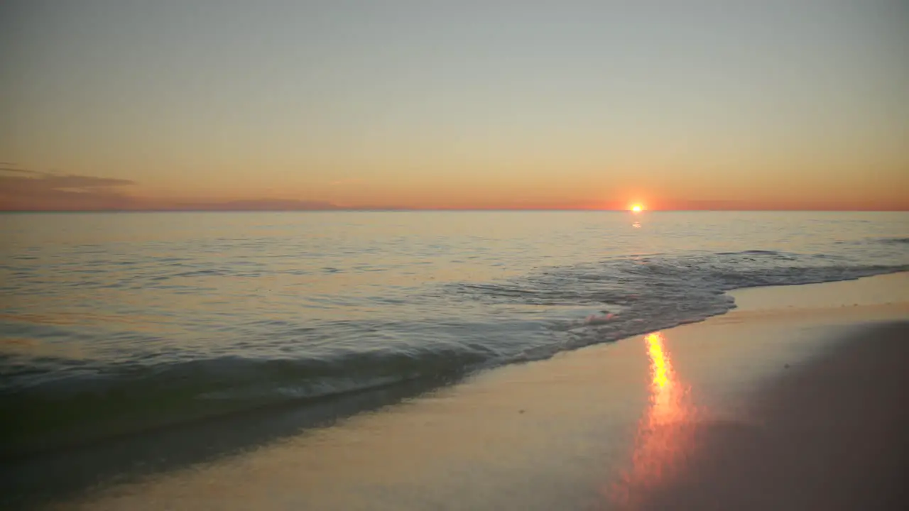 Ocean shore as the sun goes below the horizon