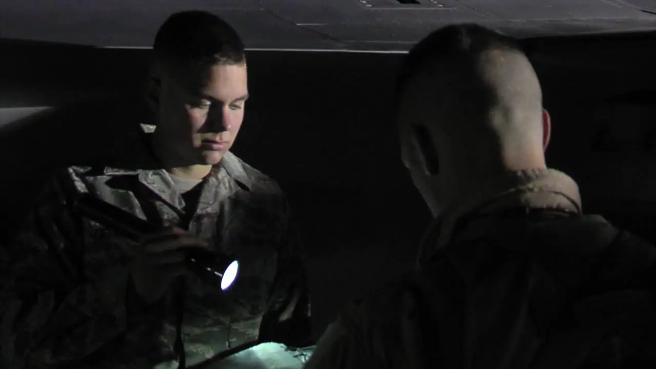 Men Prepare Their F16 Jets For A Mission At Night On A Runway