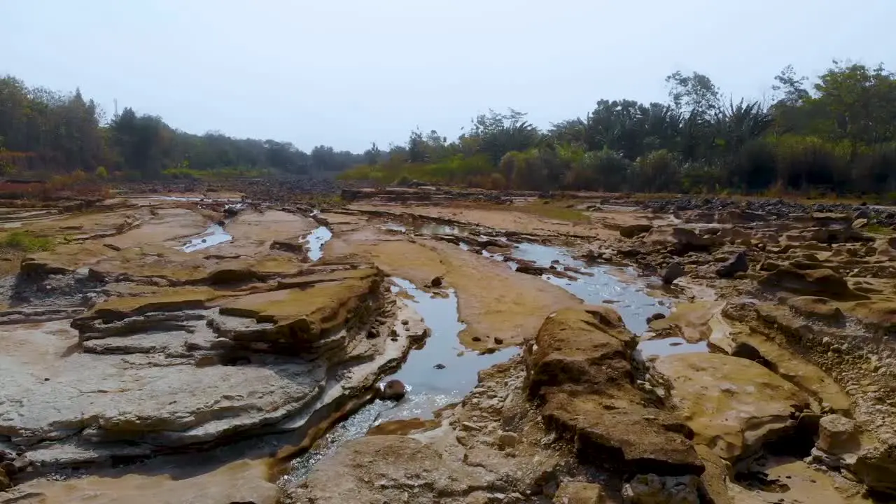 Rough eroded rocks of dry riverbed Bogowonto River Java Indonesia